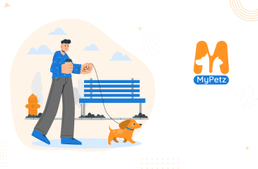 A man walking his small dog on a leash in a park, next to the "MyPetz" logo.